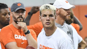 Tait Reynolds, Class of 2026 Pro style quarterback from Queen Creek High in Arizona passes near Clemson offensive coordinator Garrett Riley, left, during the 2024 Dabo Swinney Football Camp in Clemson in Clemson June 5, 2024.