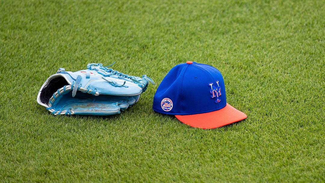 Feb 22, 2021; Port St. Lucie, Florida, USA; The hat and glove of New York Mets starting pitcher Marcus Stroman (0) sits on the outfield grass during the first day of full-squad spring training workouts at Clover Park.  Mandatory Credit: Mary Holt-USA TODAY Sports