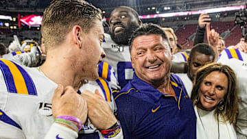 LSU quarterback Joe Burrow (9) talks with LSU head coach Ed Orgeron
