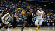 Cincinnati Bearcats guard Jizzle James (2) drives on Baylor Bears guard RayJ Dennis (10) in the second half of the Big 12 Conference tournament game between Cincinnati Bearcats and Baylor Bears at T-Mobile Center in Kansas City, Mo., on Thursday, March 14, 2024.