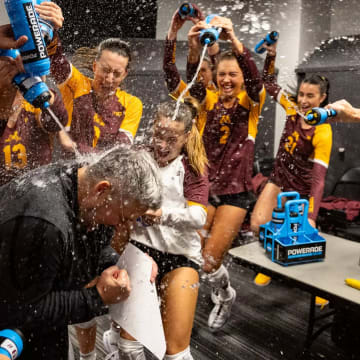 Gophers volleyball players douse coach Keegan Cook after the upset win over No. 1 Texas. 