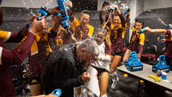 Gophers volleyball players douse coach Keegan Cook after the upset win over No. 1 Texas. 