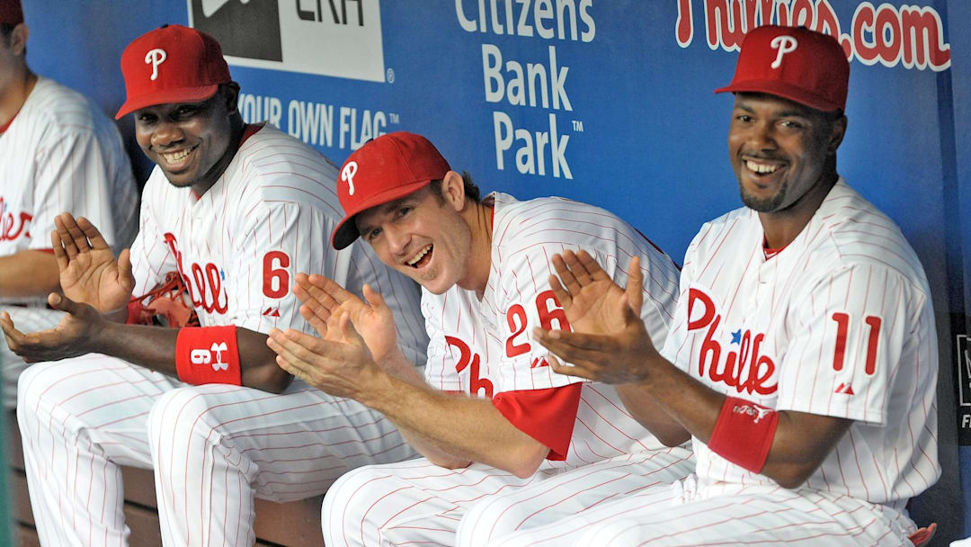 August 10, 2012; Philadelphia, PA USA; Philadelphia Phillies first baseman Ryan Howard (6), second baseman Chase Utley (26) and  shortstop Jimmy Rollins (11) applaud former Phillies teammate Mike Lieberthal (not pictured) who was inducted into the Phillies 'Wall of Fame' before the game against the St. Louis Cardinals during game at Citizens Bank Park. Mandatory Credit: Eric Hartline-Imagn Images