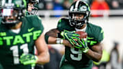Michigan State's Kenneth Walker III takes the handoff from Payton Thorne on a run against Maryland during the fourth quarter on Saturday, Nov. 13, 2021, at Spartan Stadium in East Lansing.

211113 Msu Maryland 147a