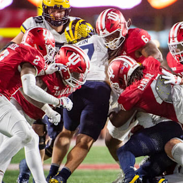 Indiana defense tackles during the Indiana versus Michigan football game at Memorial Stadium on Friday, Nov. 9, 2024.