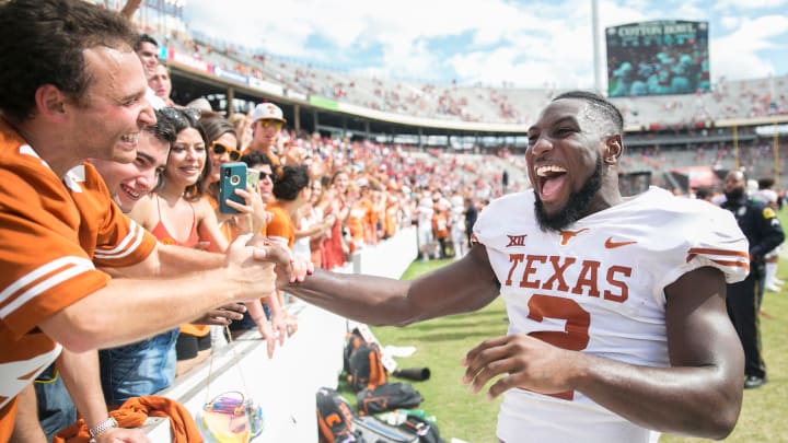 Texas Longhorns defensive back Kris Boyd (2) celebrates with Texas Longhorns fans after beating Oklahoma Sooners 48-45 during an NCAA college football game at the Cotton Bowl Stadium in Dallas Texas on Saturday, Oct. 6, 2018. [RICARDO B. BRAZZIELL/AMERICAN-STATESMAN]