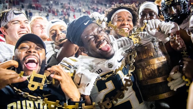 Purdue's Sanoussi Kane and the Boilermakers celebrate with the Old Oaken Bucket after defeating the Indiana Hoosiers.