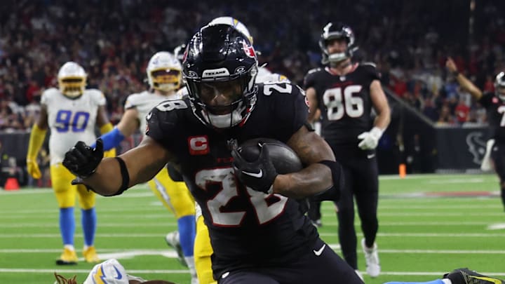 Jan 11, 2025; Houston, Texas, USA;  Houston Texans running back Joe Mixon (28) scores a touchdown against the Los Angeles Chargers in the fourth quarter in an AFC wild card game at NRG Stadium. Mandatory Credit: Thomas Shea-Imagn Images