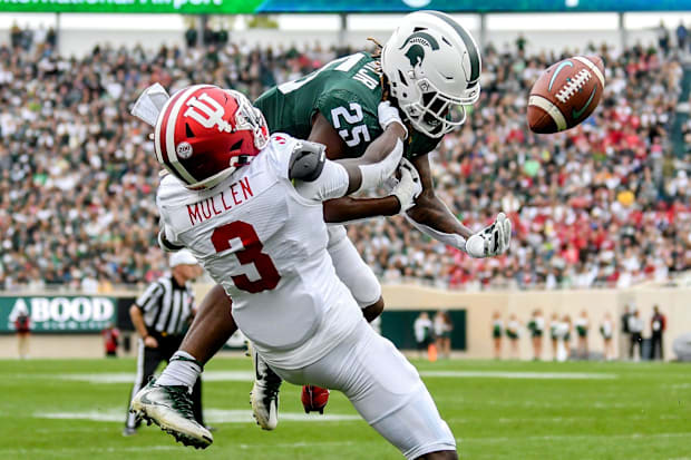 Michigan State's Darrell Stewart Jr., top, can't hold on to the ball as Indiana's Tiawan Mullen defends.