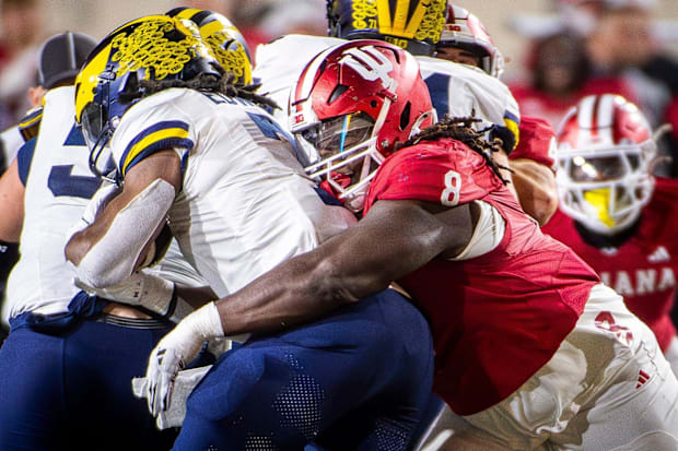 Indiana's CJ West tackles Michigan's Donovan Edwards at Memorial Stadium.