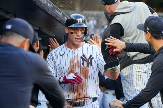 Aaron Judge high-fives Yankees teammates in dugout at Yankee Stadium in Bronx, N.Y.