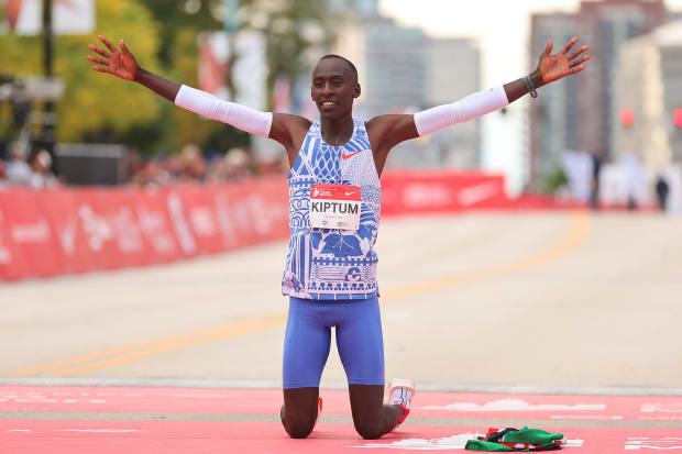 Marathon runner Kelvin Kipton drops to his knees in celebrationi at the finish line. 