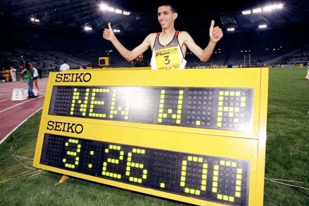 Morocco's Hicham El Guerrouj stands by a signing showing his new world record of 3:26.00 in the 1,500.