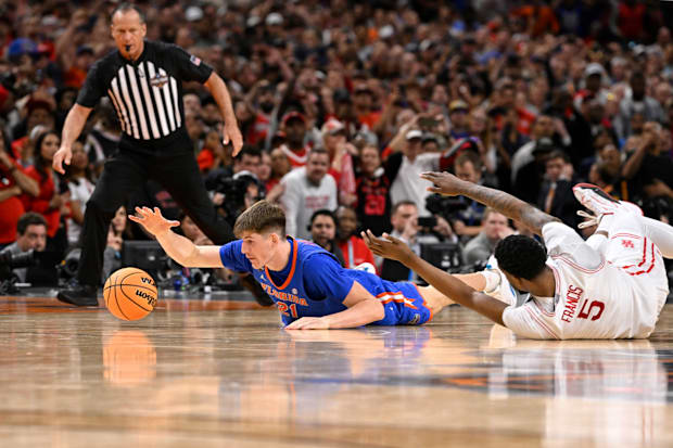 Florida's Alex Condon dives on the ground and reaches for the ball.