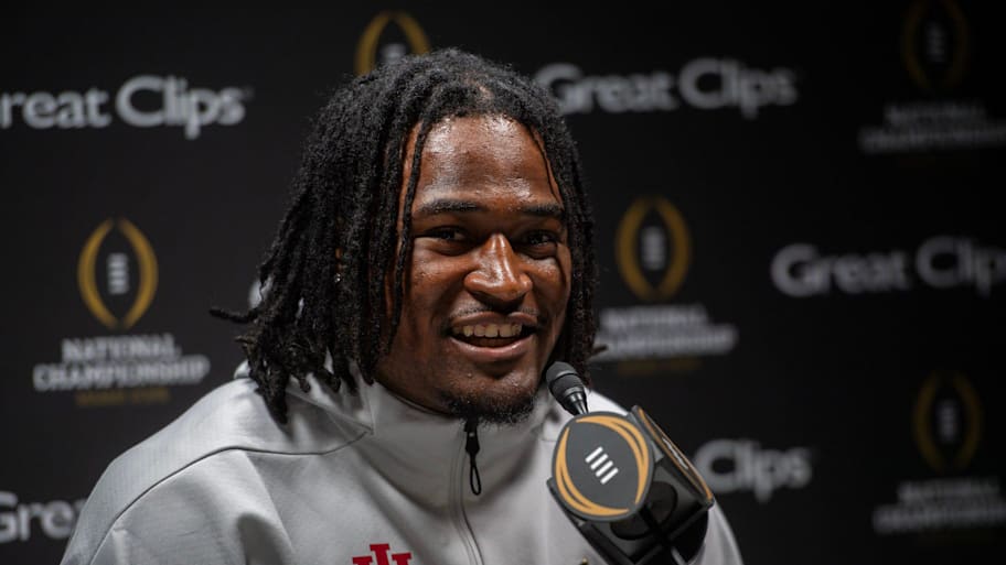 Kaelon Black answers questions at a podium wearing an Indiana zip-up.