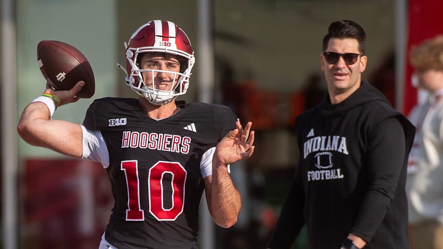 Indiana QB Josh Hoover throws in front of Hoosiers co-offensive coordinator and quarterbacks coach Tino Sunseri.