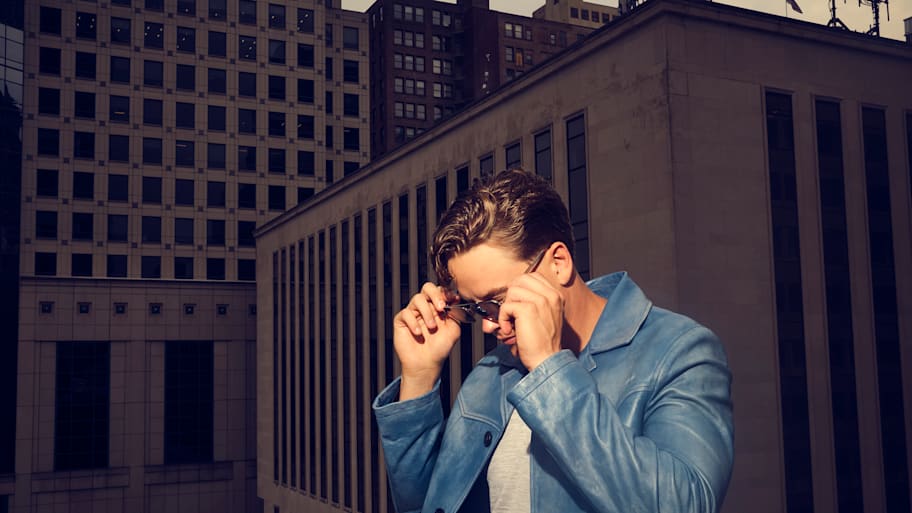 Joe Burrow poses with sunglasses on a rooftop