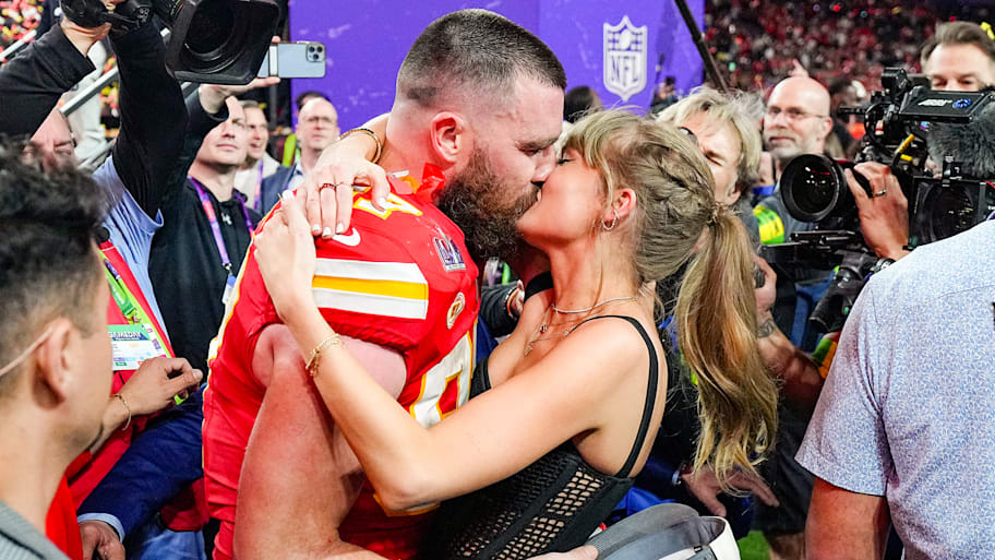 Chiefs Travis Kelce (87) kisses girlfriend and singer Taylor Swift following the Super Bowl