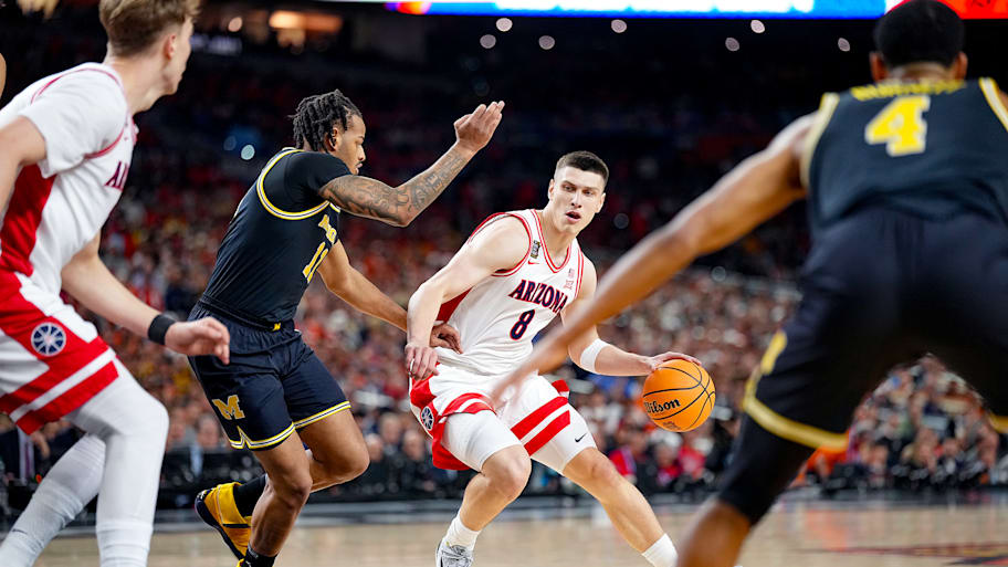 Arizona’s Ivan Kharchenkov drives to the hoop with the ball against Michigan in the men’s Final Four.