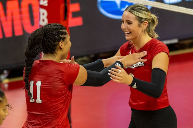 Nebraska outside hitter Teraya Sigler (left) and middle blocker Kenna Cogill celebrate a point during the Red-White Scrimmage