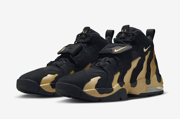 Side view of Deion Sanders' black and gold Nike sneakers.