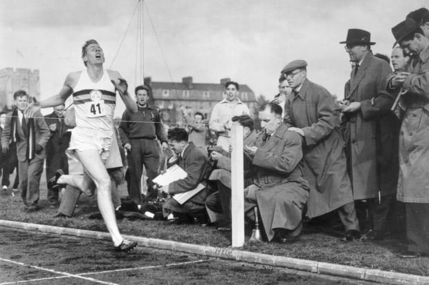 Roger Bannister crosses the finish line while setting the first four-minute mile in May 1954. 