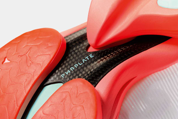 Black and orange PUMA running shoe outsole.