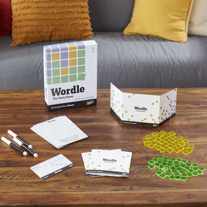 Wordle party game set-up shot with components laid out on a table