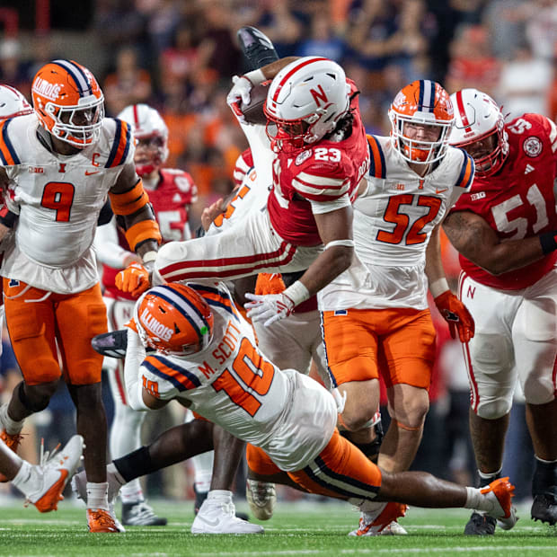 Nebraska running back Dante Dowdell is brought down by Illinois defensive back Miles Scott after a 7-yard gain.