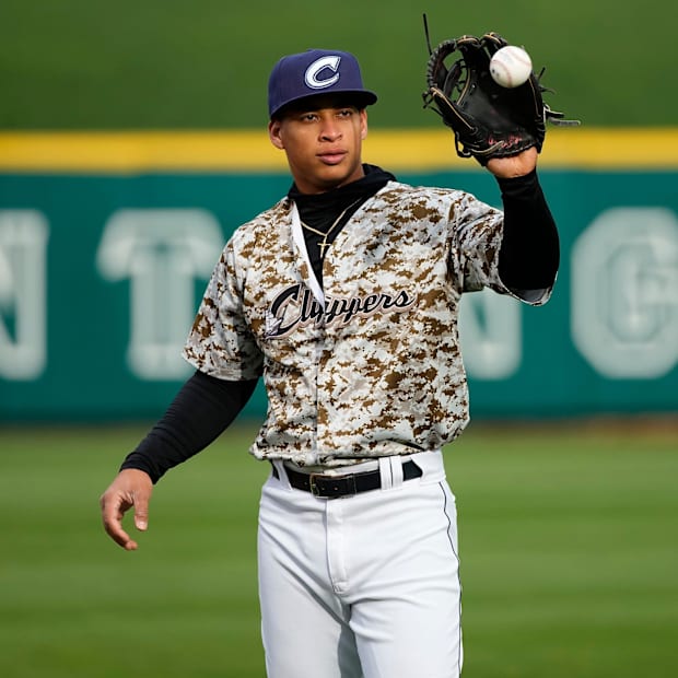 uan Brito (24) warms up prior to the Opening Day