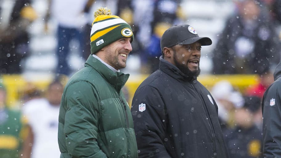 Dec 22, 2013; Green Bay, WI, USA; Green Bay Packers quarterback Aaron Rodgers and Pittsburgh Steelers head coach Mike Tomlin talk during warmups prior to the game at Lambeau Field. Mandatory Credit: Jeff Hanisch-Imagn Images | Jeff Hanisch-Imagn Images