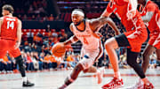 Illinois guard Kylan Boswell (4) drives to the basket against an Illinois State defender in the Illini's 92-65 exhibition win Sunday at State Farm Center in Champaign, Illinois.