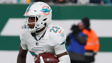 Jan 5, 2025; East Rutherford, New Jersey, USA; Miami Dolphins running back De'Von Achane (28) runs with the ball during the first quarter of their game against the New York Jets at MetLife Stadium. Mandatory Credit: Ed Mulholland-Imagn Images