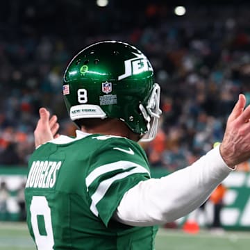 Jan 5, 2025; East Rutherford, New Jersey, USA; New York Jets quarterback Aaron Rodgers (8) celebrates his touchdown pass to New York Jets wide receiver Davante Adams (17) (not pictured) during the fourth quarter of their game against the Miami Dolphins at MetLife Stadium. Mandatory Credit: Ed Mulholland-Imagn Images