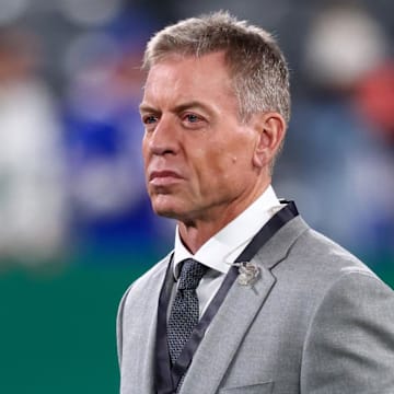 Troy Aikman walks the field during the pregame warmups for the NFL game between the New York Jets and the Buffalo Bills.