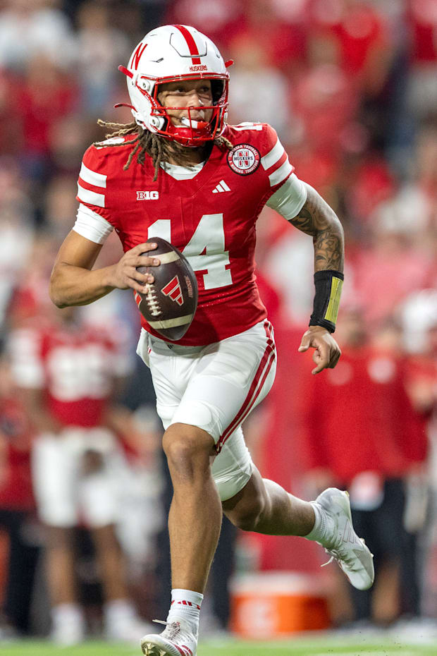Nebraska quarterback TJ Lateef scrambles for a 9-yard gain against Akron.