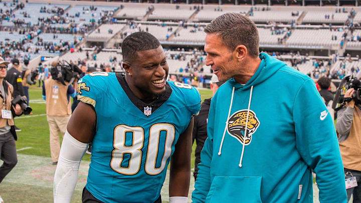 Jacksonville Jaguars tight end Quintin Morris (80) has a laugh with Jacksonville Jaguars Executive Vice President of Football Operations Tony Boselli after the game at EverBank Stadium, Sunday, Jan. 4, 2026, in Jacksonville, Fla. 