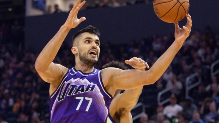 Apr 14, 2024; San Francisco, California, USA; Utah Jazz center Omer Yurtseven (77) grabs a rebound in front of Golden State Warriors forward Trayce Jackson-Davis during the first quarter at Chase Center. Mandatory Credit: D. Ross Cameron-USA TODAY Sports