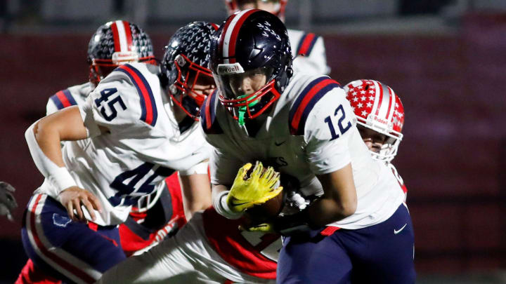 Sophomore Robert Lathon looks for running room during the second quarter of Sheridan's 34-27 win against Columbus Hartley in a Division IV, Region 15 semifinal on Friday at Newark's White Field. Lathon, with more than 1,500 yards entering the game, had 26 carries for 173 yards with four touchdowns.