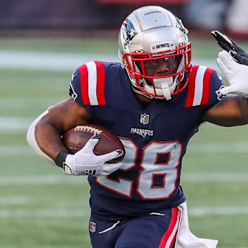 Nov 29, 2020; Foxborough, Massachusetts, USA; New England Patriots running back James White (28) runs the ball against the Arizona Cardinals during the second half at Gillette Stadium. Mandatory Credit: Paul Rutherford-Imagn Images