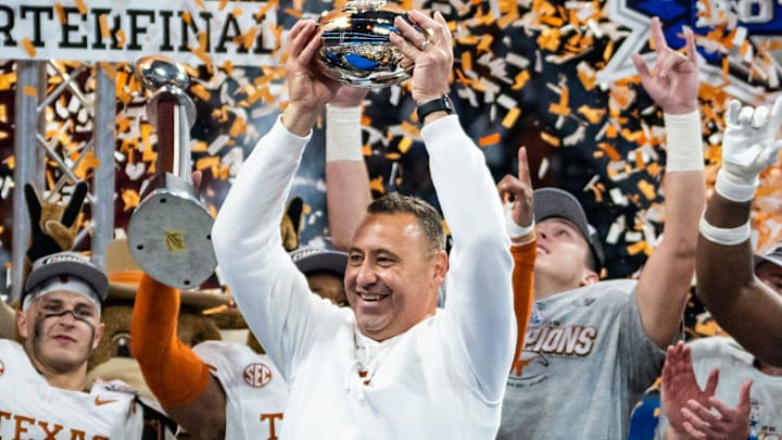 Texas Longhorns head coach Steve Sarkisian raises the trophy as the Texas Longhorns celebrate their 39-31 double overtime win over the Arizona State Sun Devils in the Peach Bowl College Football Playoff quarterfinal at Mercedes-Benz Stadium in Atlanta, Georgia, Jan. 1, 2025.