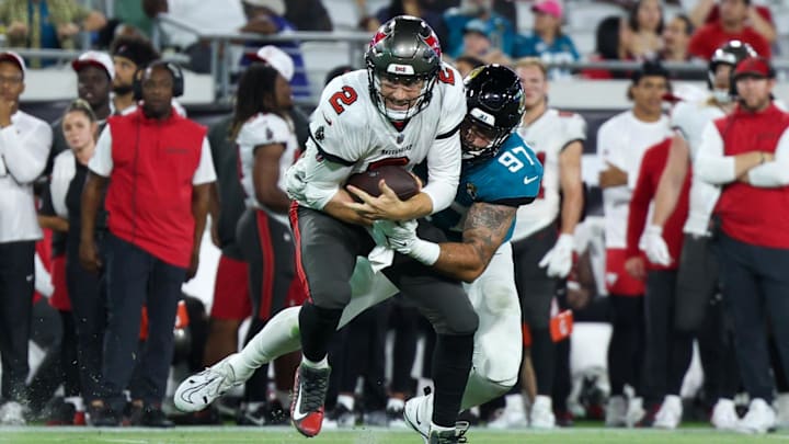 Aug 17, 2024; Jacksonville, Florida, USA; Jacksonville Jaguars defensive end Rasheem Green (97) sacks Tampa Bay Buccaneers quarterback Kyle Trask (2) in the fourth quarter during a preseason game at EverBank Stadium. Mandatory Credit: Nathan Ray Seebeck-Imagn Images