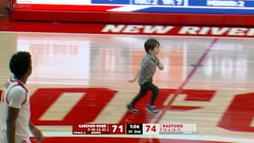 A young fan runs on the court during Radford vs. Gardner-Webb men's basketball.