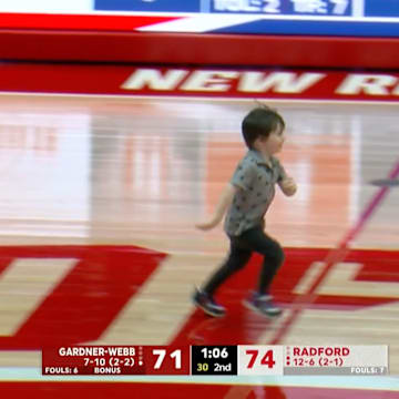 A young fan runs on the court during Radford vs. Gardner-Webb men's basketball.