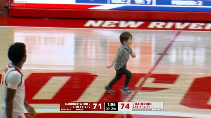 A young fan runs on the court during Radford vs. Gardner-Webb men's basketball.
