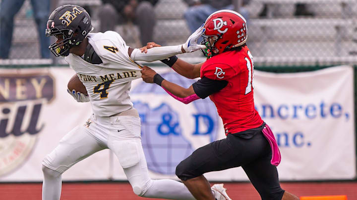 Fort Meade Miners Omari Russell (4) tries to elude Dixie County Bears Javan Wilson (10) in the first half. Fort Meade Miners played the Dixie County Bears in the Florida Invitational Tournament at The Range at HG Morse Stadium in Sumterville, FL on Friday, December 6, 2024. The Miners defeated the Bears 21-13. [Doug Engle/Gainesville Sun]