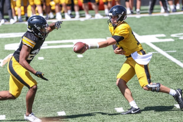 Iowa's Cade McNamara hands the ball off to Kamari Moulton during practice on Aug. 10, 2024 in Iowa City. (Rob Howe/HN) 