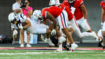 Oct 26, 2024; Tucson, Arizona, USA; Arizona Wildcats defensive back Dalton Johnson (43) tackles West Virginia Mountaineers during the second quarter at Arizona Stadium. Mandatory Credit: Aryanna Frank-Imagn Images
