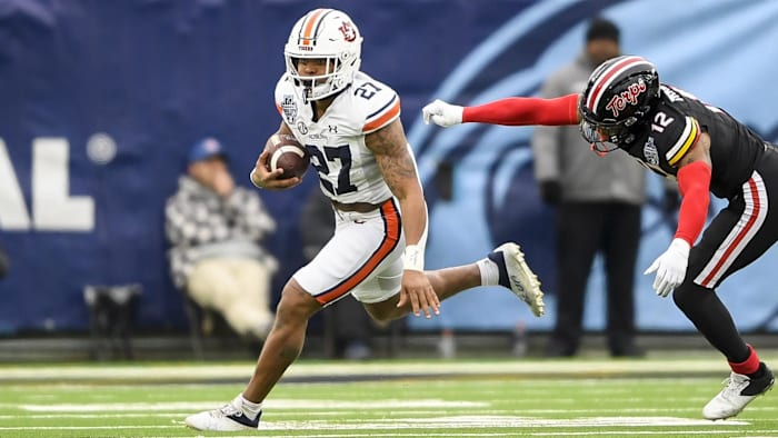 Dec 30, 2023; Nashville, TN, USA; Auburn Tigers running back Jarquez Hunter (27) runs the ball