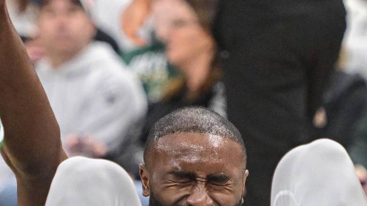 Apr 3, 2026; Milwaukee, Wisconsin, USA;  Boston Celtics forward Jaylen Brown (7) is helped up after a foul in the third quarter against the Milwaukee Bucks at Fiserv Forum. Mandatory Credit: Benny Sieu-Imagn Images